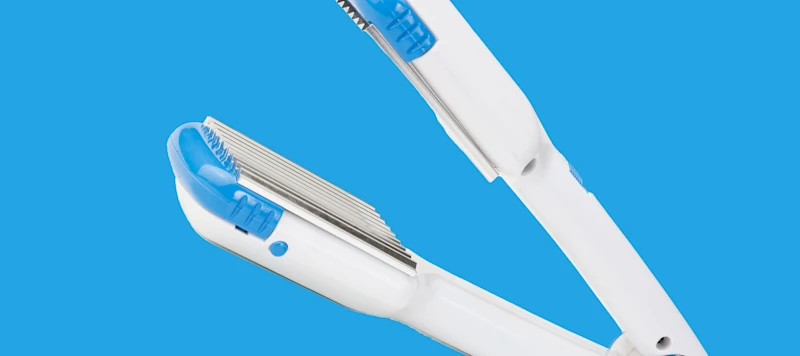Crimping Iron in front of a Blue Background