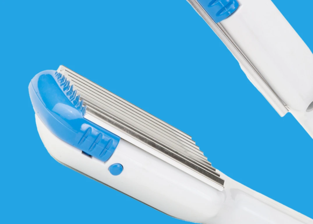Crimping Iron in front of a Blue Background