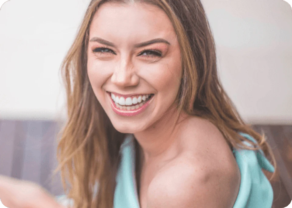 Smiling Caucasian woman with straight 2a blonde hair woman wearing sea foam green outfit