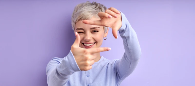 Cheerful happy woman with short hair laughing, feeling happiness