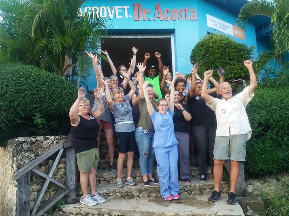 Finding balance through affordable vet care standing in front of latin american clinic