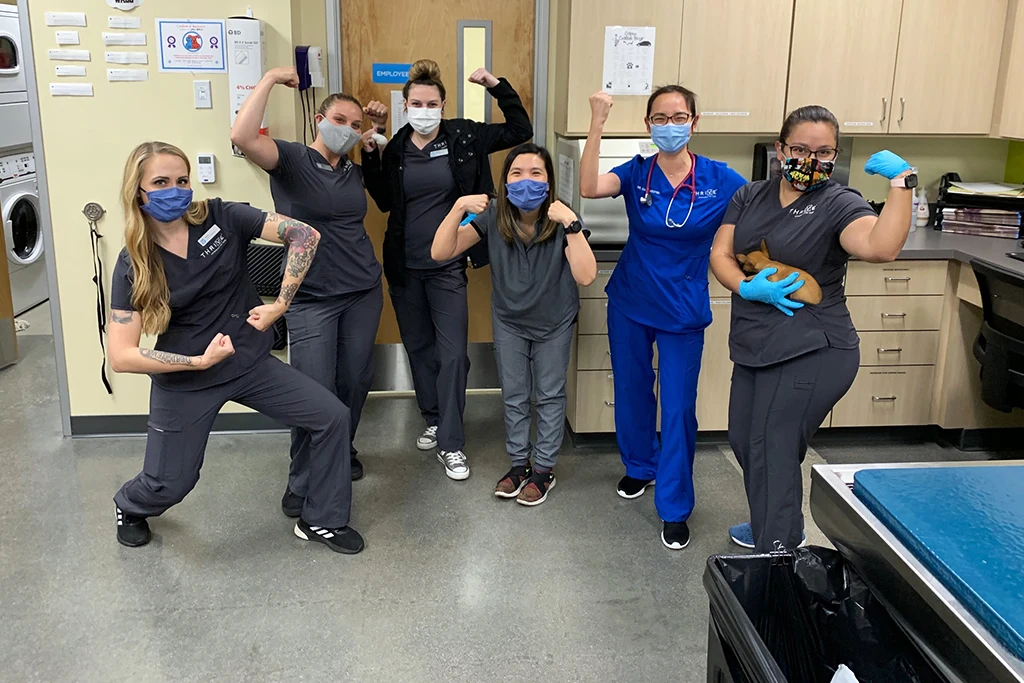 Thrive team posing with masks on announcing new policy