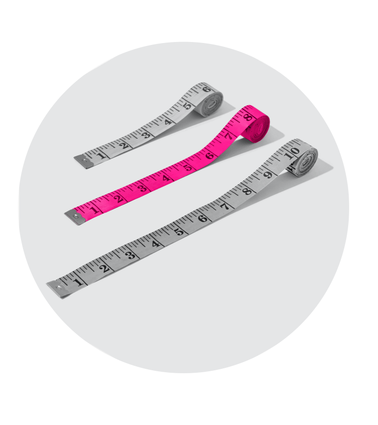 Image of two grey measuring tapes and one pink measuring tape within a hexagon on grey background.