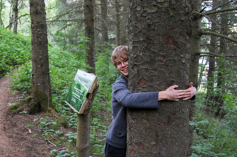 Hugging Iceland's tallest tree. Photo credits: Pétur Halldórsson