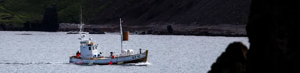 Small fishing vessel in a fjord
