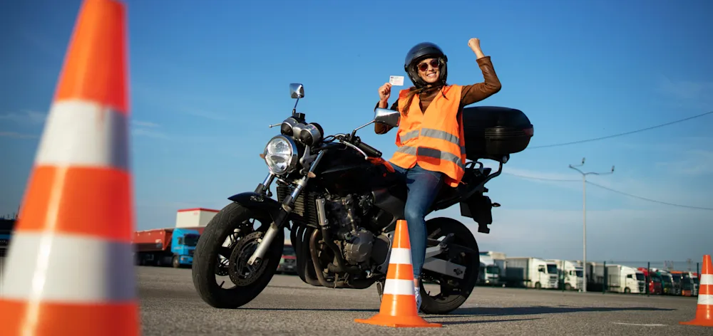 Motorcycle riding past a cone