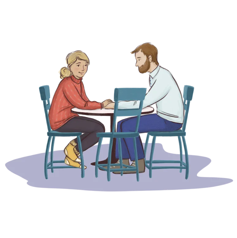 Maður og kona sitja við borð