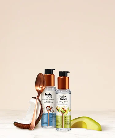 Hair Food oil bottles with coconut and avocado ingredients and copper spoon