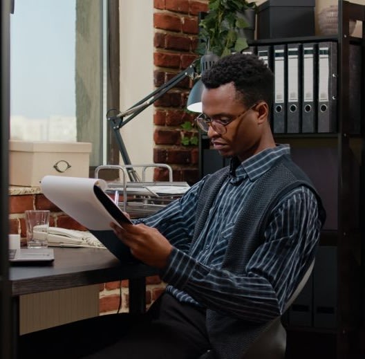 Planning project with laptop and paperwork