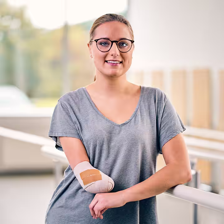 An amputee poses happily