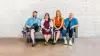 Four people sitting on a bench. A man with a below the knee prosthetic leg, a woman with a bebionic hand, a woman with a C-Leg prosthetic knee joint and a woman with a trans-tibial prosthesis.