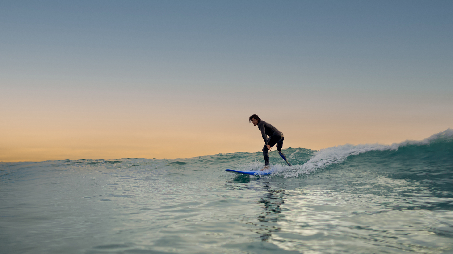 An amputee surfing in the water with his Ottobock Genium X4. 