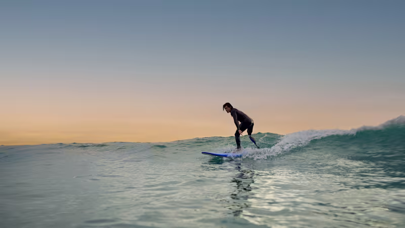 An amputee surfing in the water with his Ottobock Genium X4.