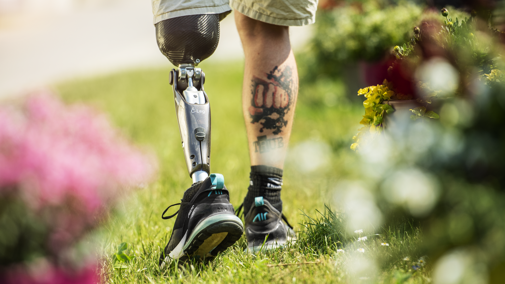 Prosthetic leg user walking outside with their C-Leg