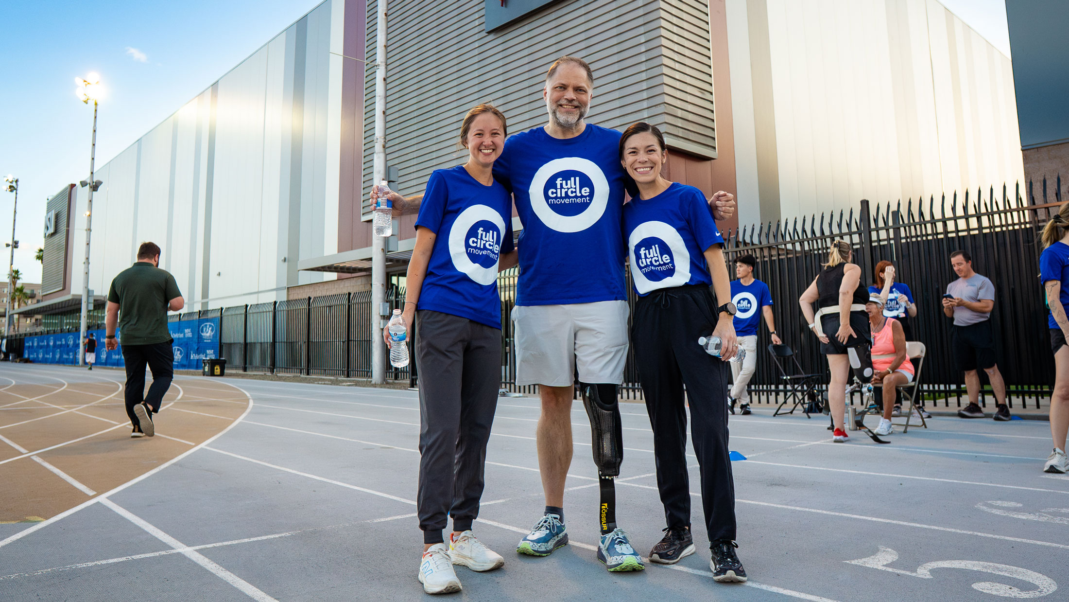Volunteers pose with a Full Circle Movement attendee 