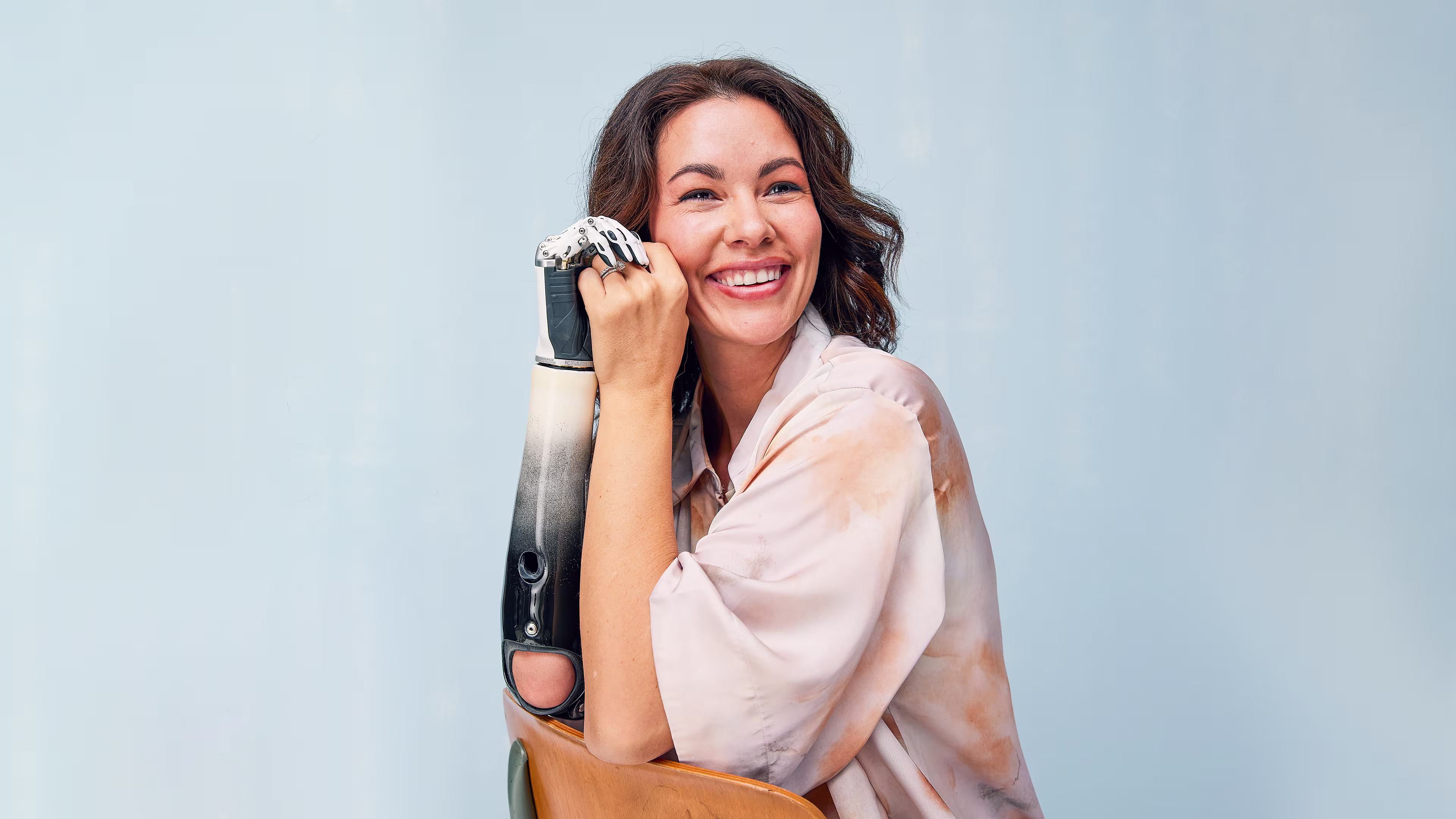 Shaholly smiles largely as she poses with her custom Ottobock bebionic hand
