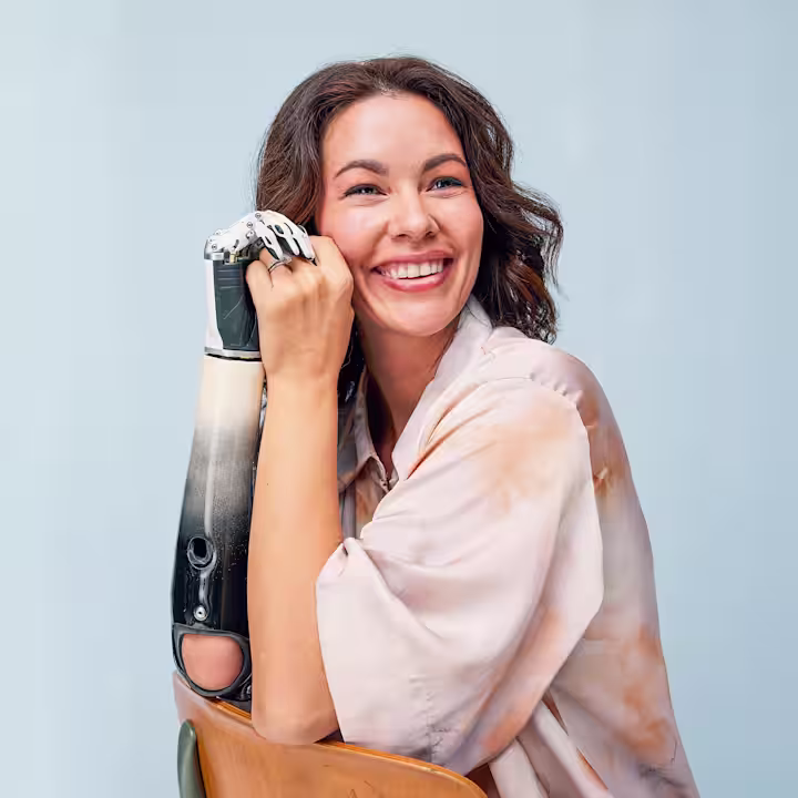 Shaholly smiles largely as she poses with her custom Ottobock bebionic hand