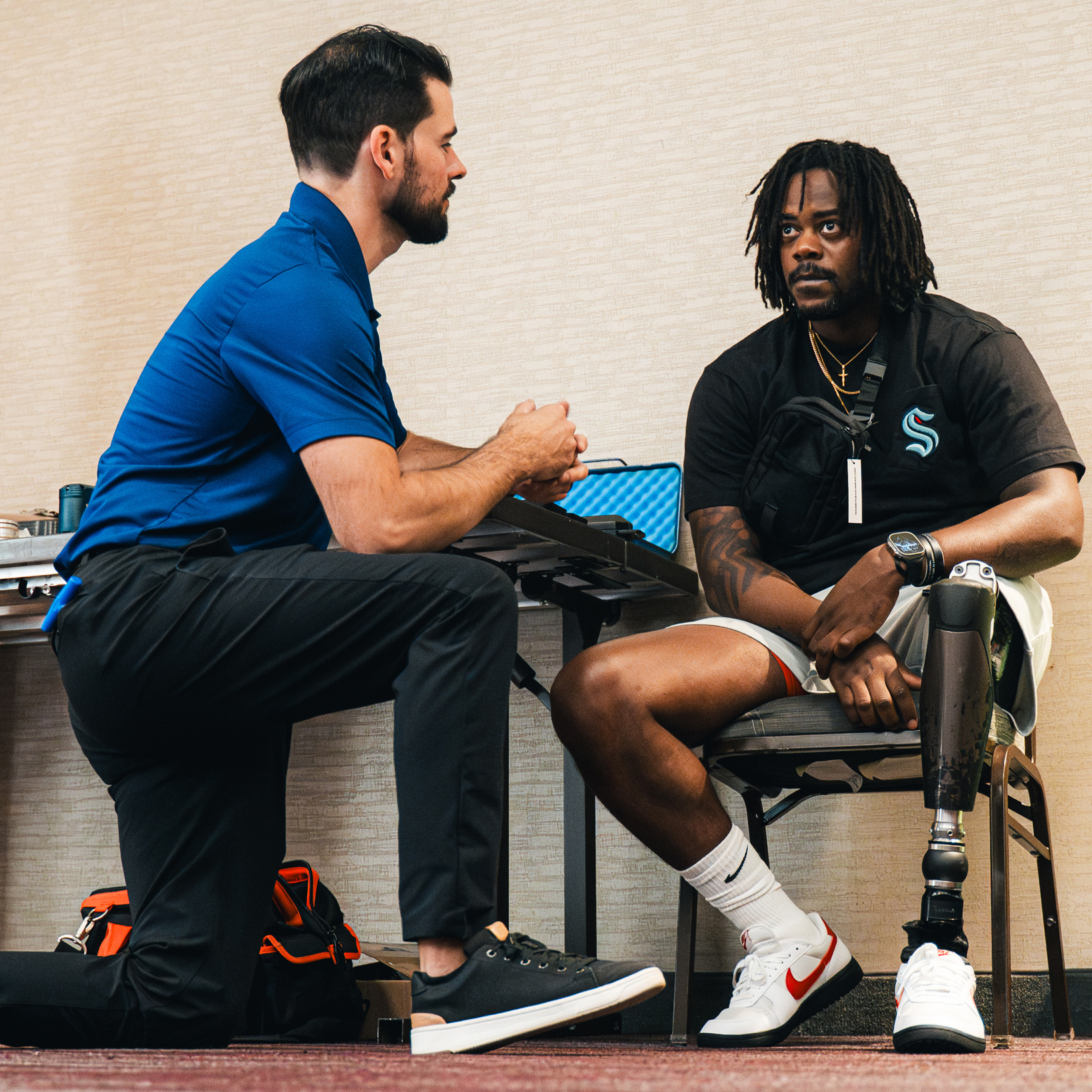 A Certified Prosthetist Orthotist (CPO) consulting with a leg prosthesis user during a Running Clinic event