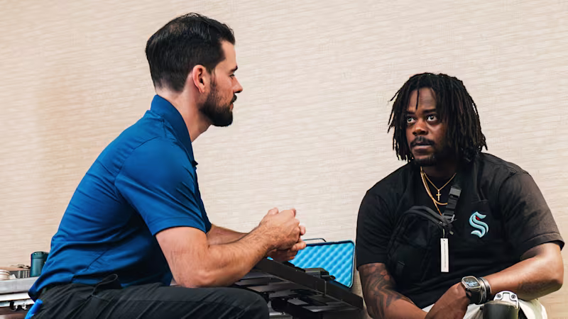 A Certified Prosthetist Orthotist (CPO) consulting with a leg prosthesis user during a Running Clinic event