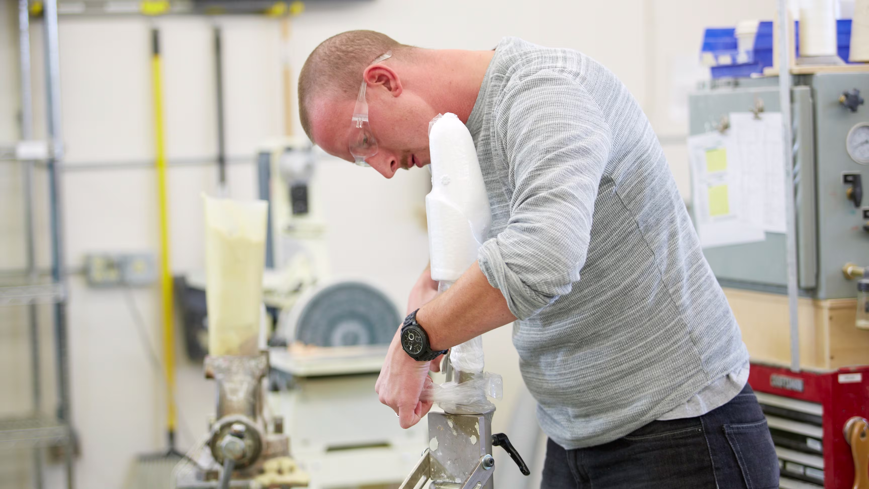 Person preparing upper limb mold for lamination.
