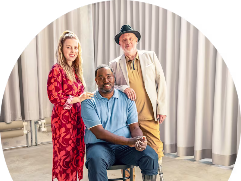 Three Ottobock prosthetic leg users posing together for a photo.