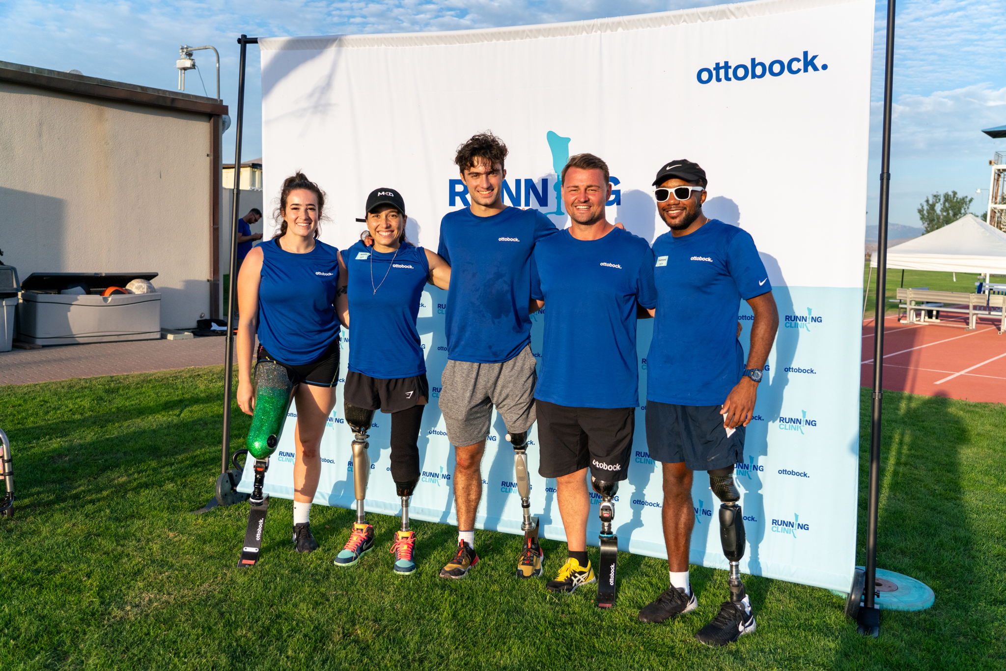 Running Clinic participants pose in front of an Ottobock backdrop 