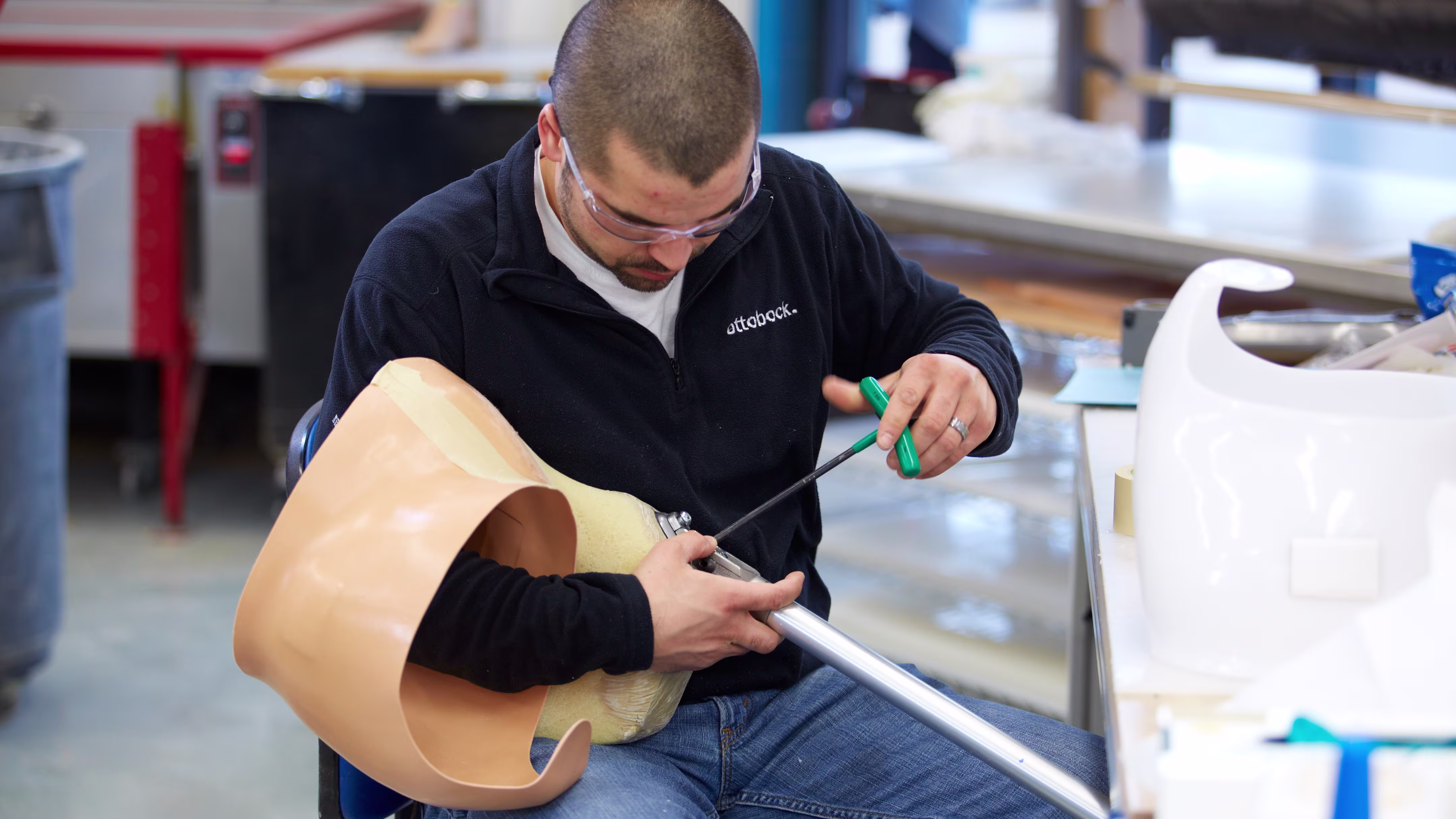 Technician working on prosthetic hip socket.