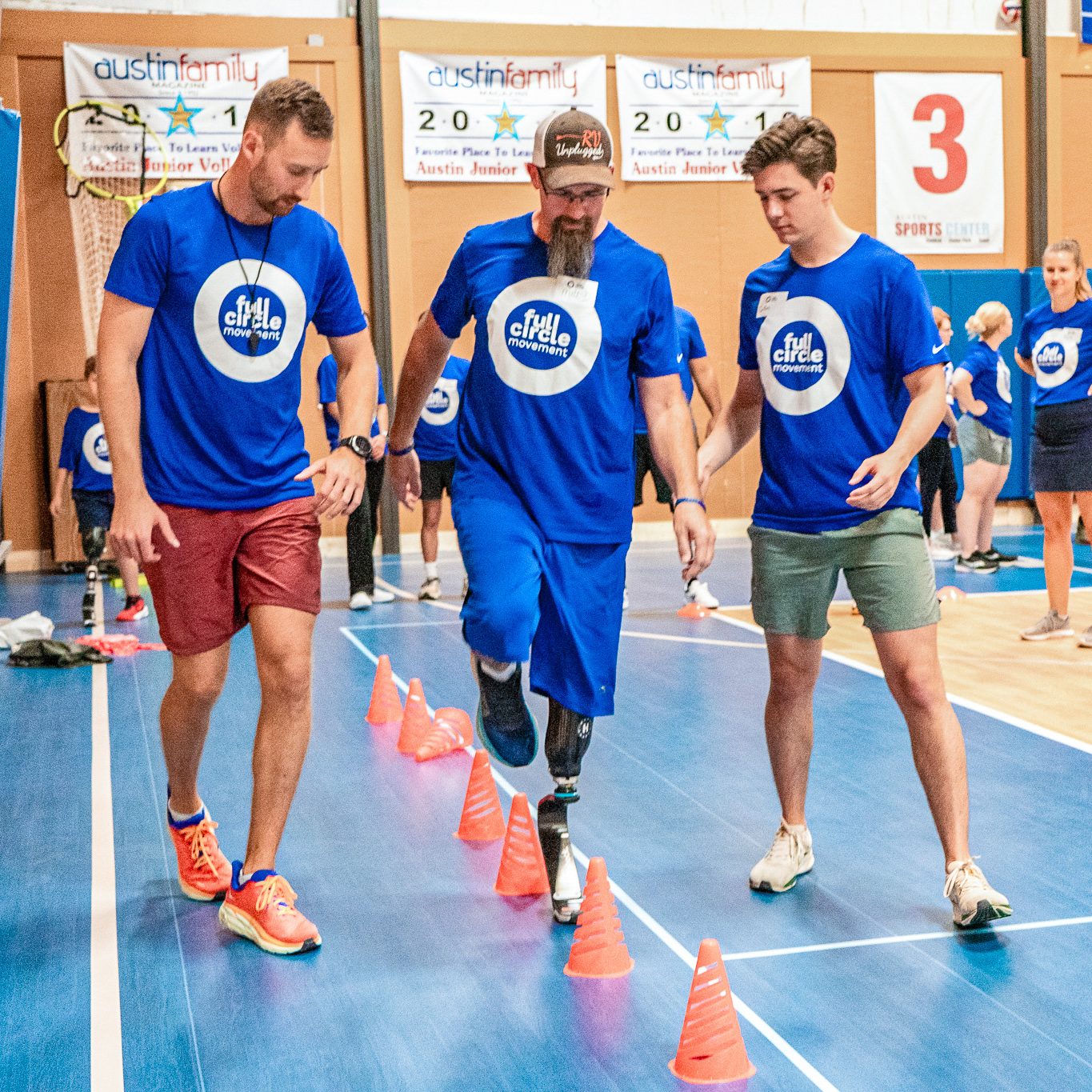 A group of Full Circle Movement Participants walking along the course in an indoor gymnasium 