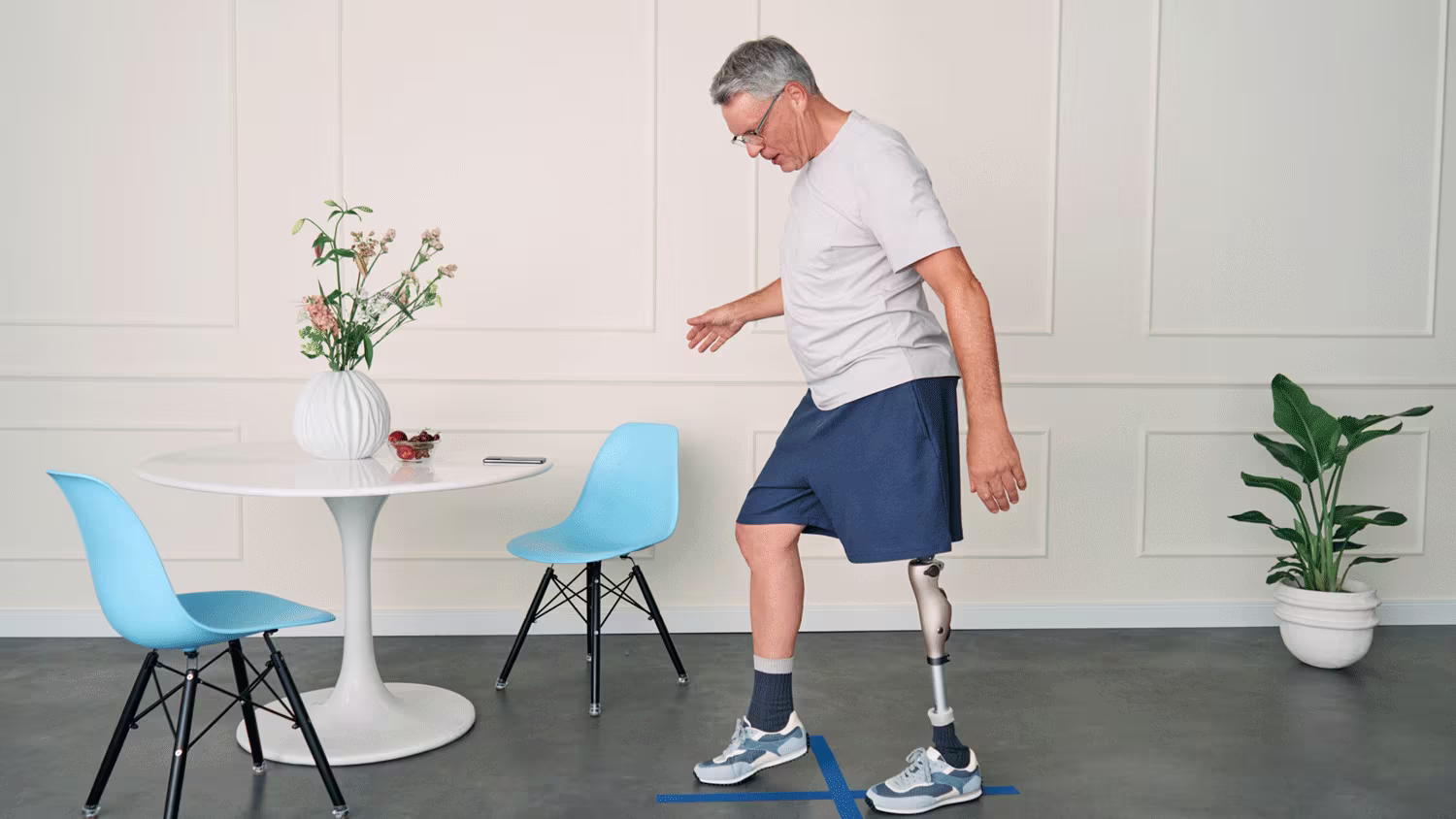 A lower limb amputee walking in his Ottobock Kenevo artificial leg and Kintrol prosthetic foot