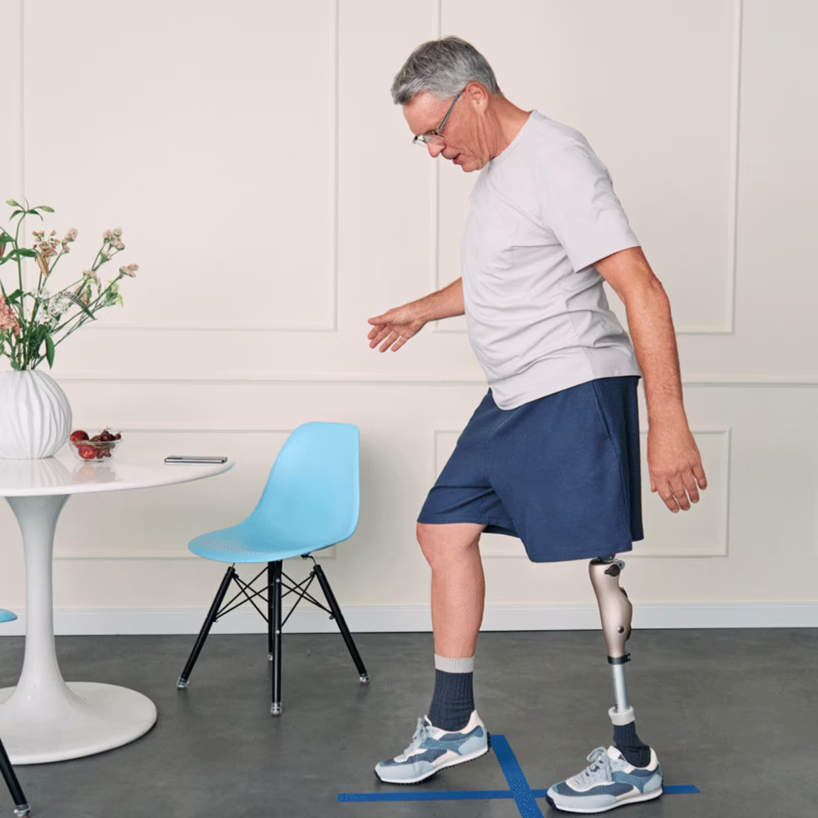 A lower limb amputee walking in his Ottobock Kenevo artificial leg and Kintrol prosthetic foot