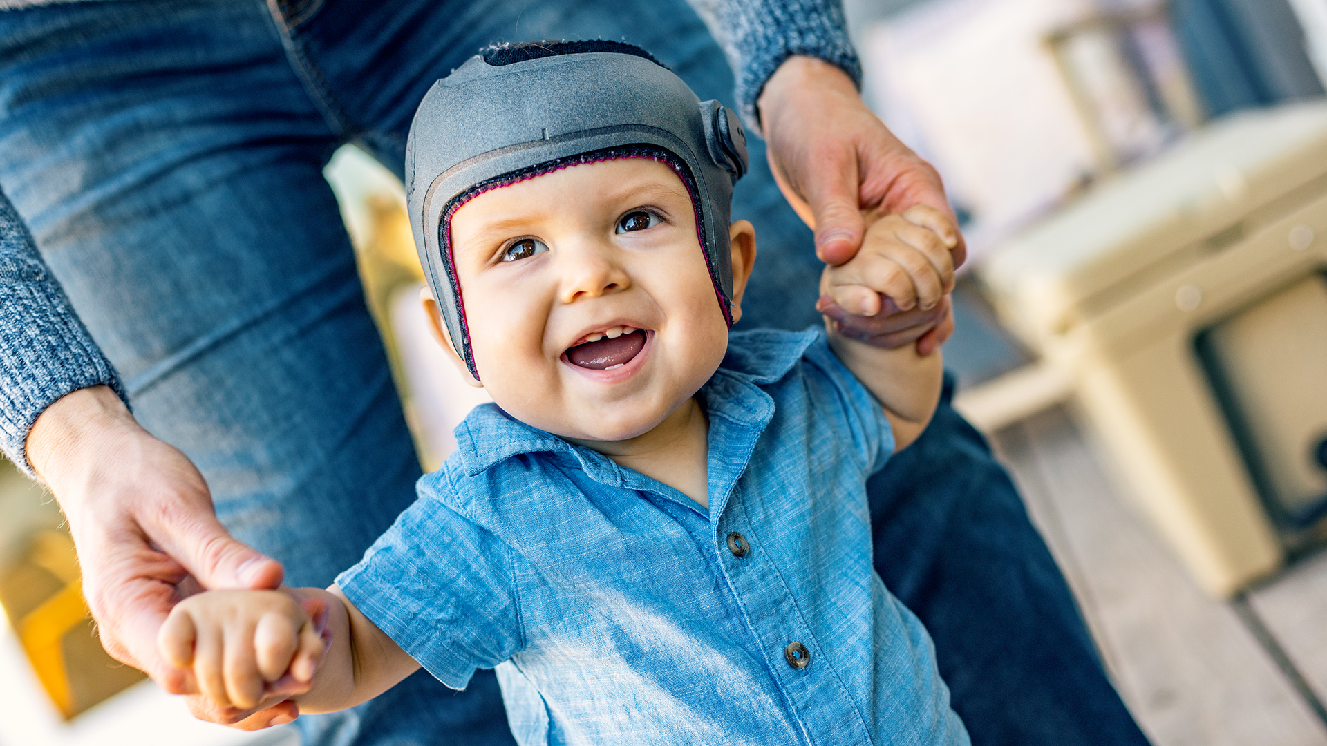 A young child enjoys playing with their parent while wearing their custom-made MyCRO Band