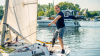 A male user is standing on a sailing boat with his Taleo Side Flex foot.