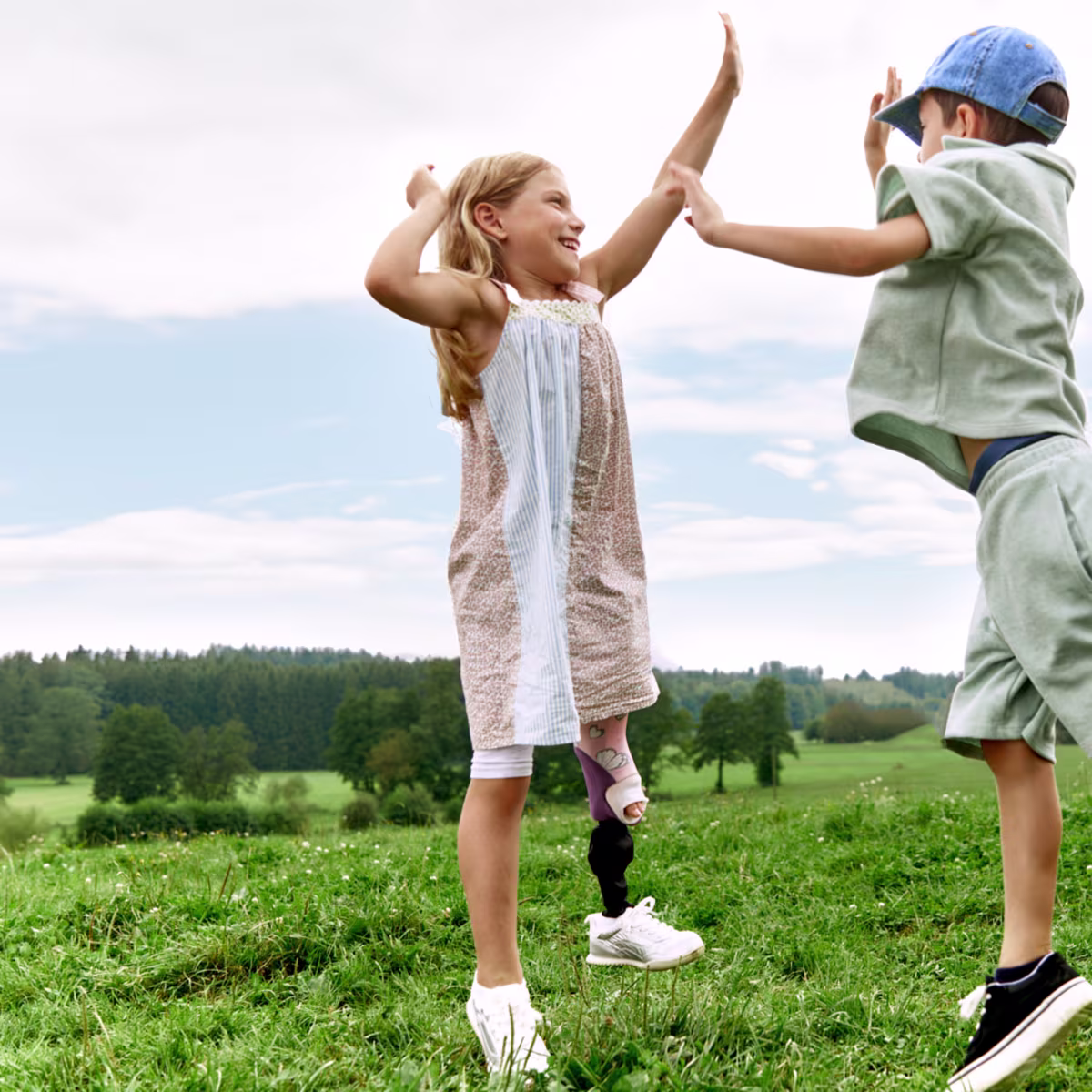 Two children with Ottobock leg prostheses spending time outdoors.