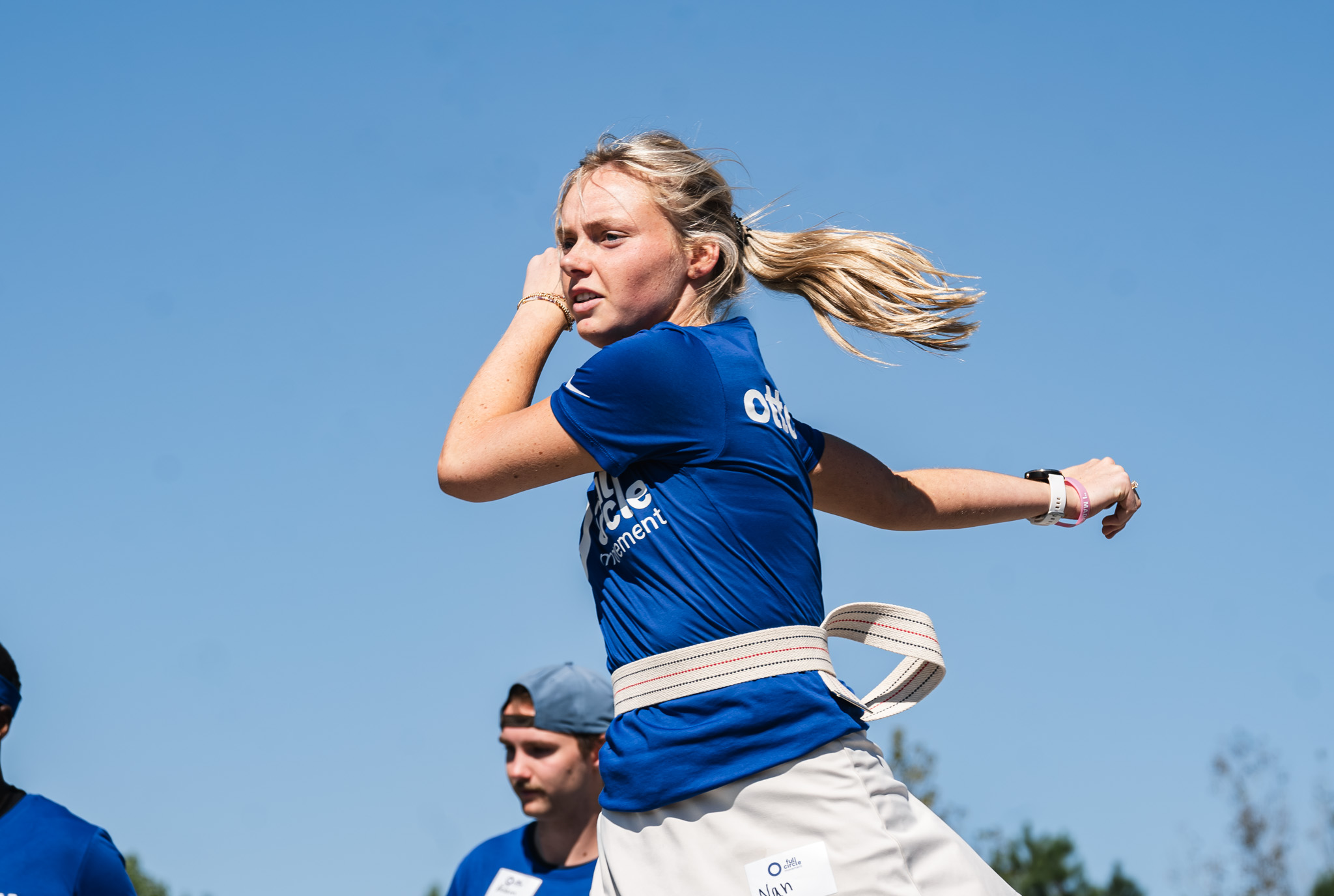 A prosthetic user stretching to prepare for the Ottobock Running Clinic