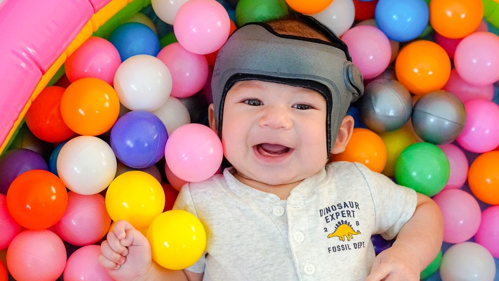 A child playing in a ball pit