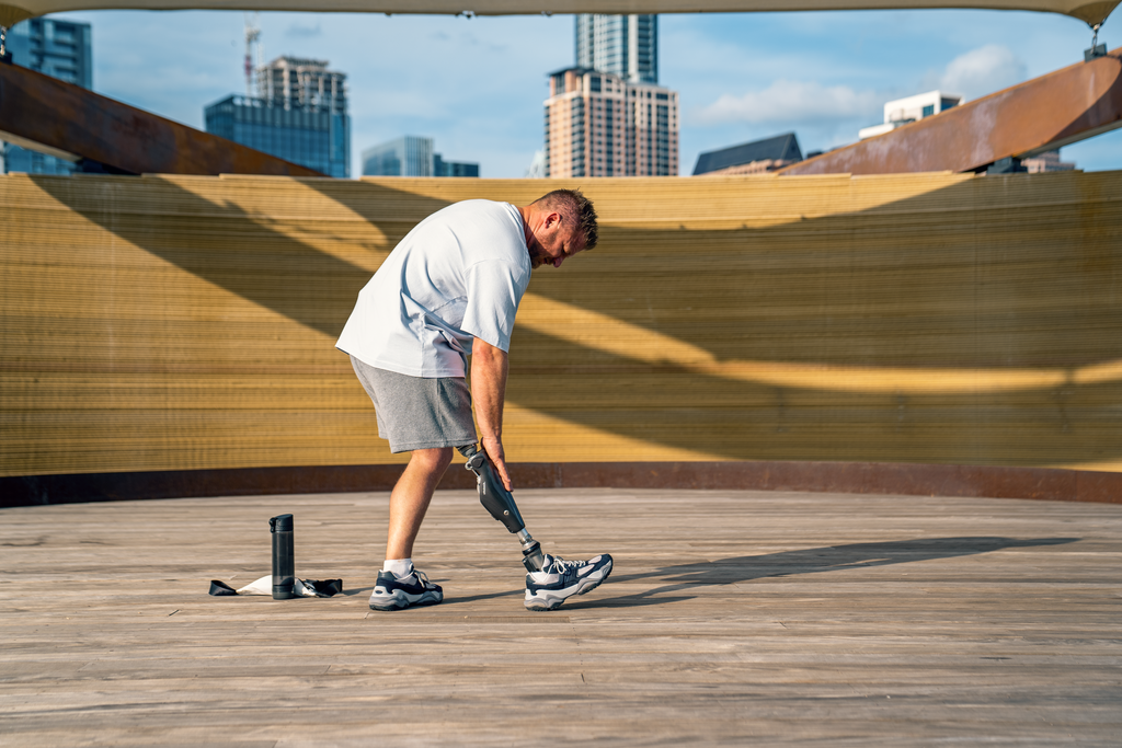 C‑Leg user Chance exercises in a modern environment with a city skyline in the background.