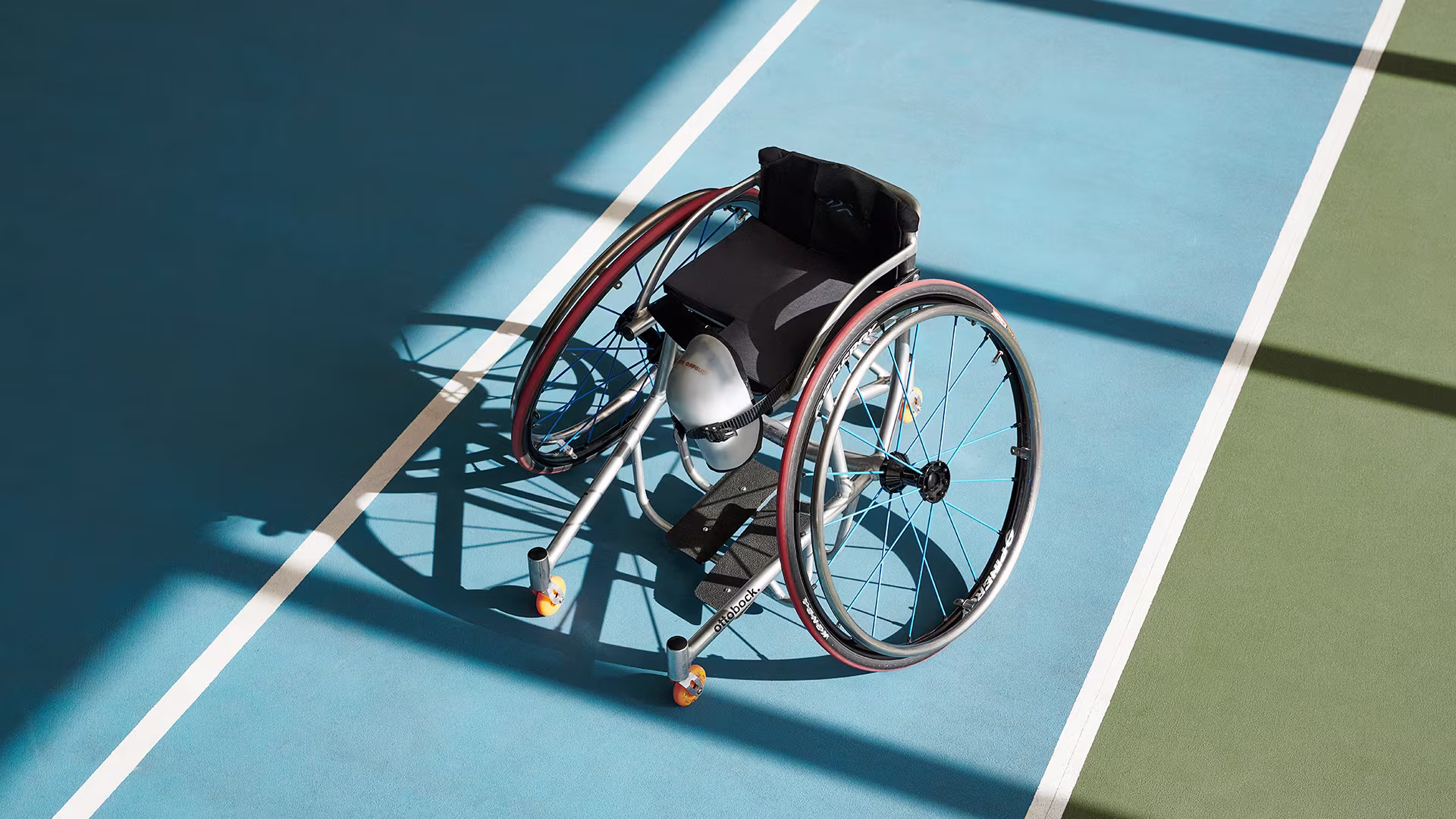 Ottobock Invader tennis wheelchair stands on a tennis court