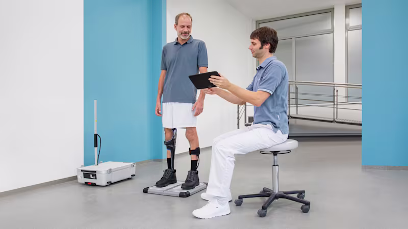 A Certified Orthotist reviewing the gait of a patient in the C-Brace