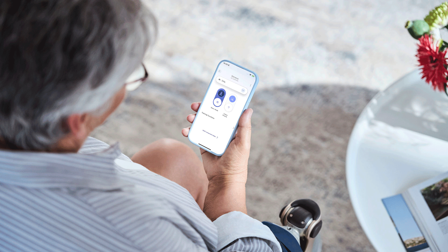 A prosthetic leg user using their connectgo app to adjust their Kenevo artificial knee 
