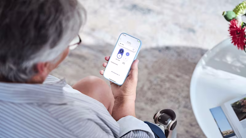 A prosthetic leg user using their connectgo app to adjust their Kenevo artificial knee