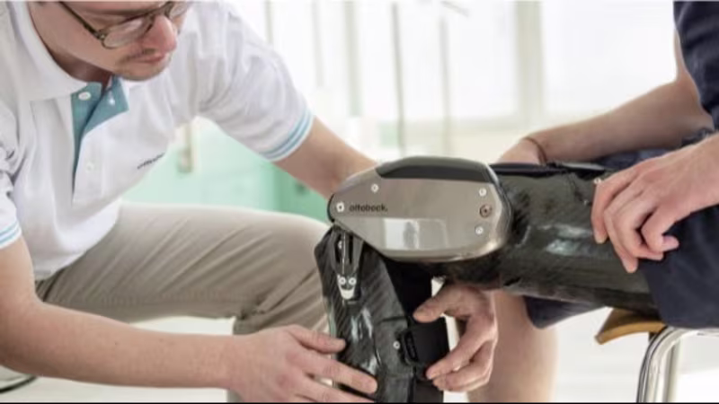 Practitioner fitting a C-Brace.