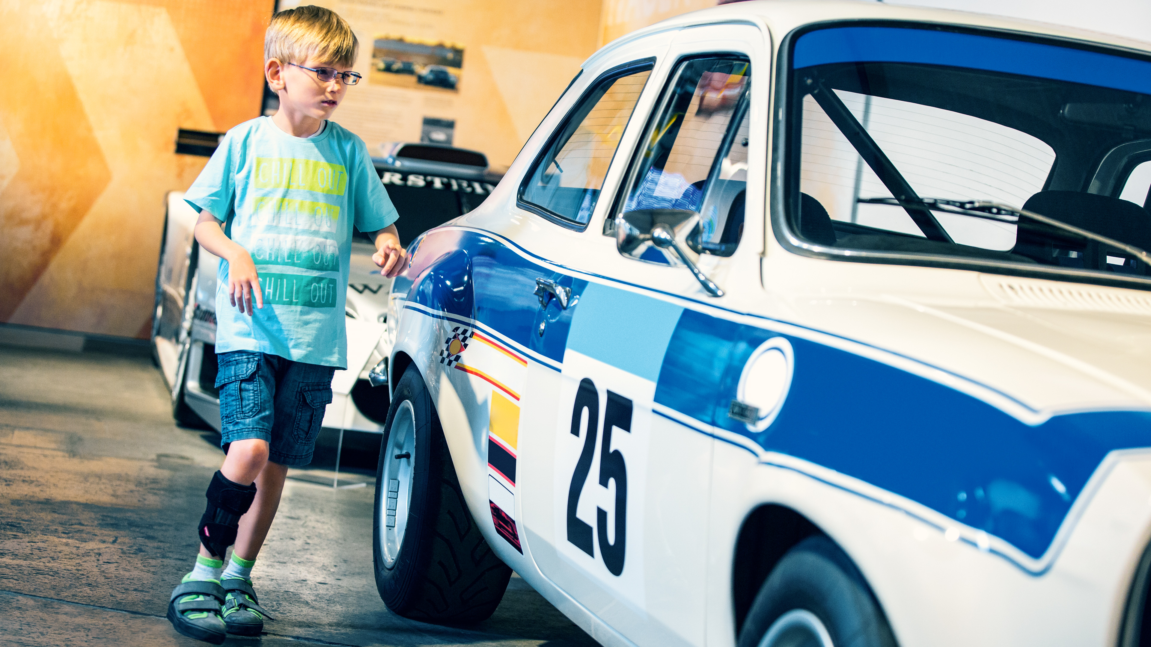 Leo wears the WalkOn Reaction junior and walks past motorcycles.