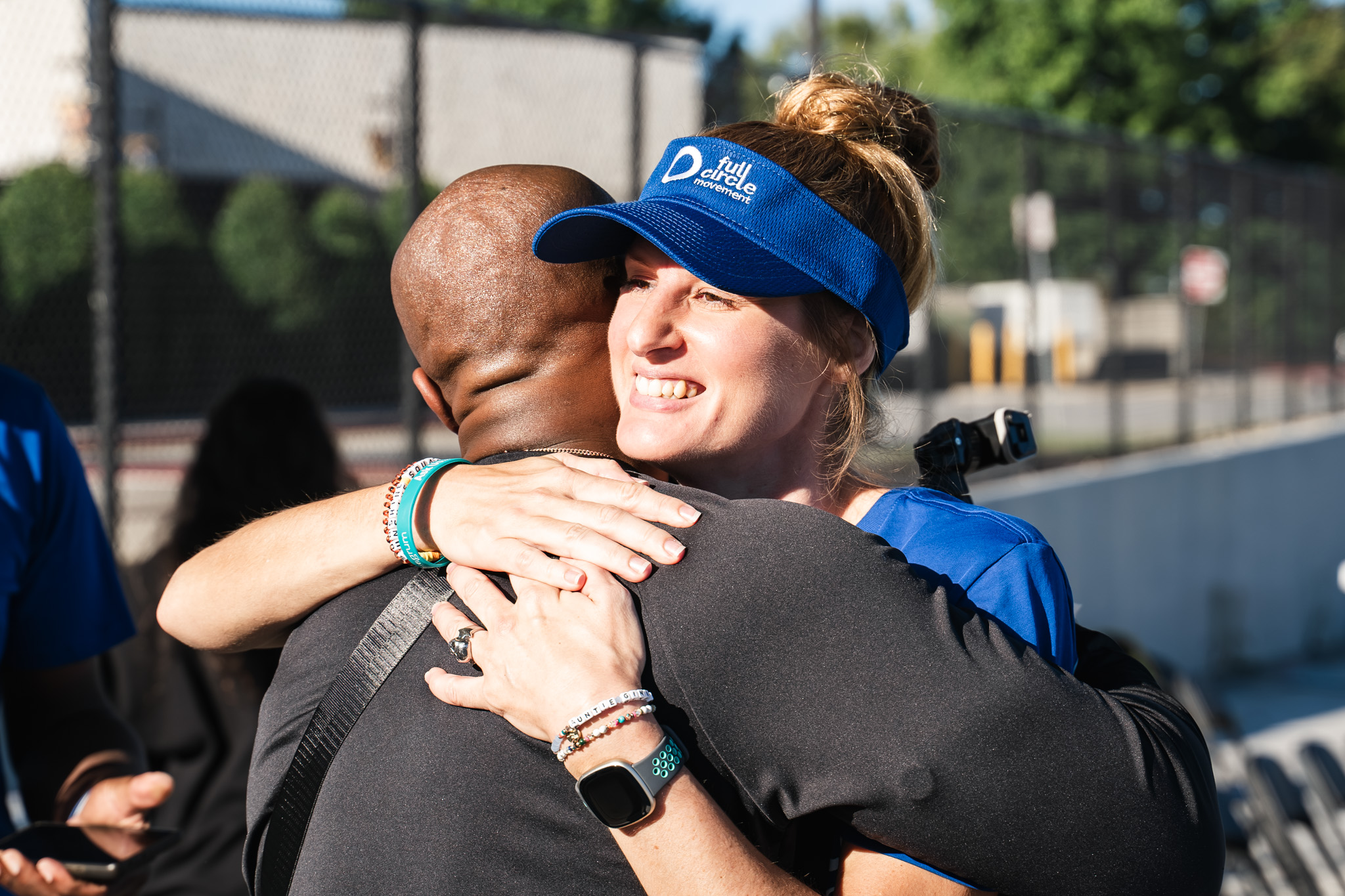 A volunteer for the Ottobock Full Circle Movement hugging an attendee 
