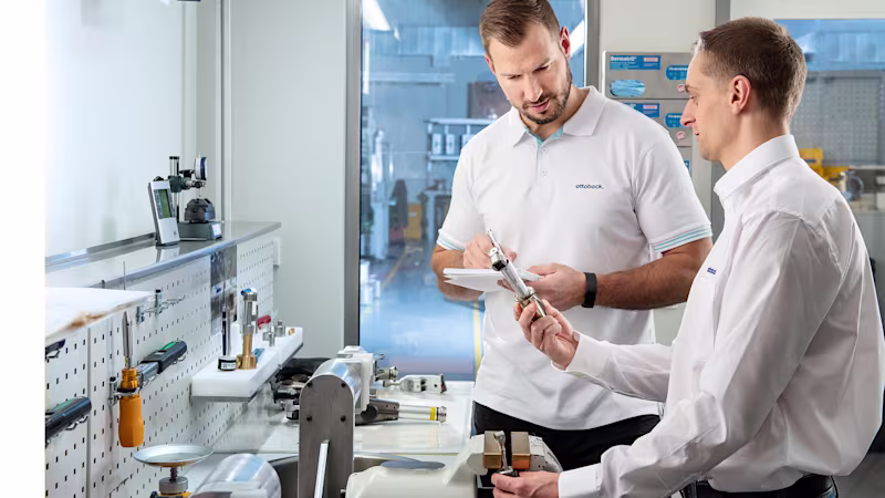 Two Ottobock CPOs assembling and talking about a product in their workshop.