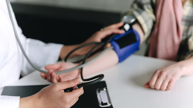 A patient having their blood pressure calculated