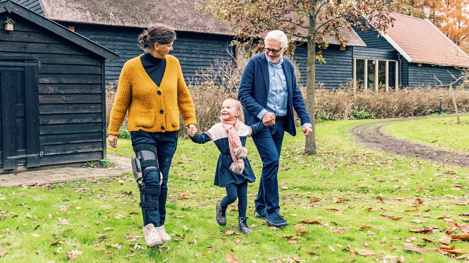 Marjan is wearing the C-Brace and walking outside with her family.