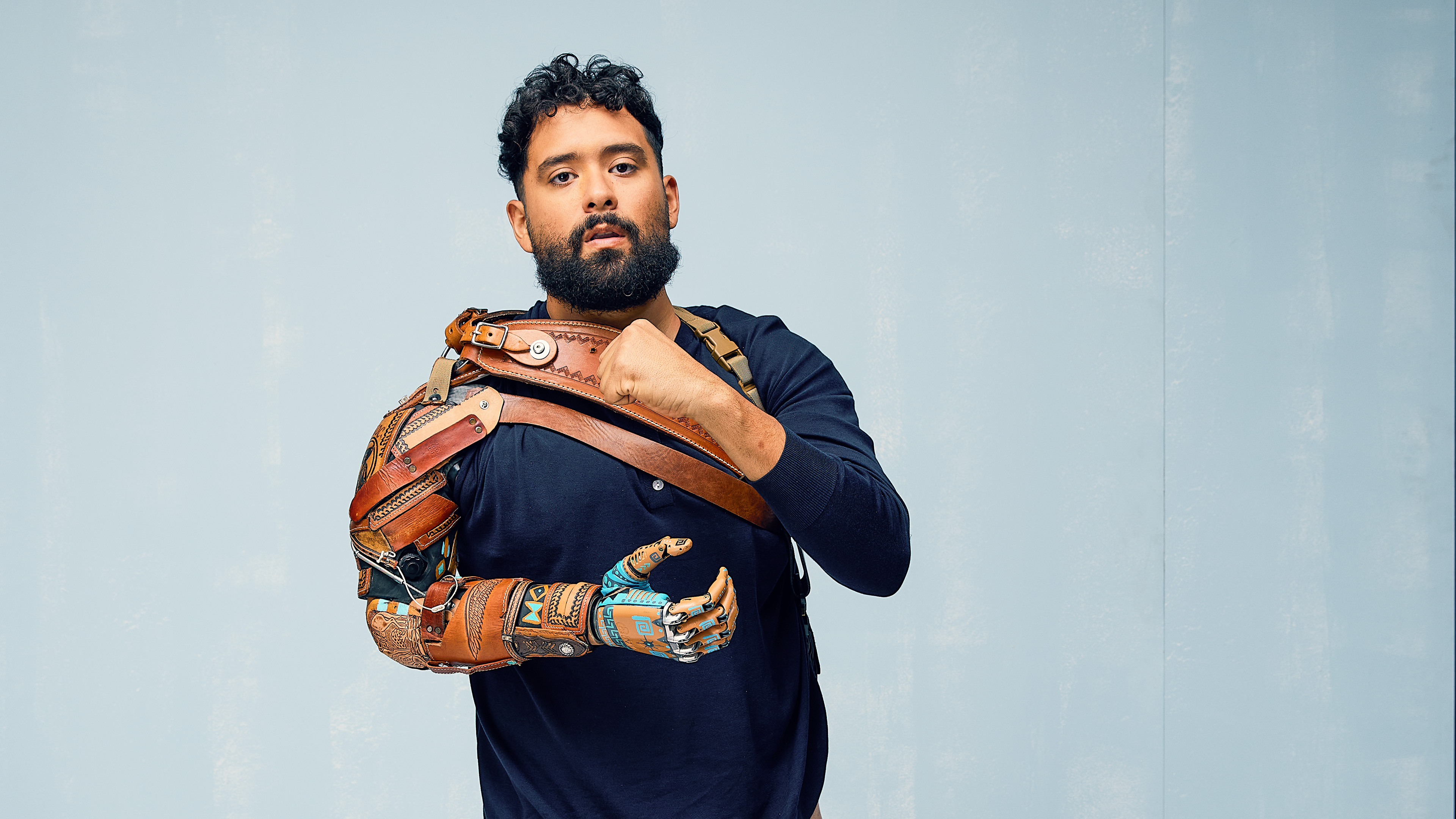 Veteran Sebastian wears his custom and unique bionic hand while clinching his other hand into a fist