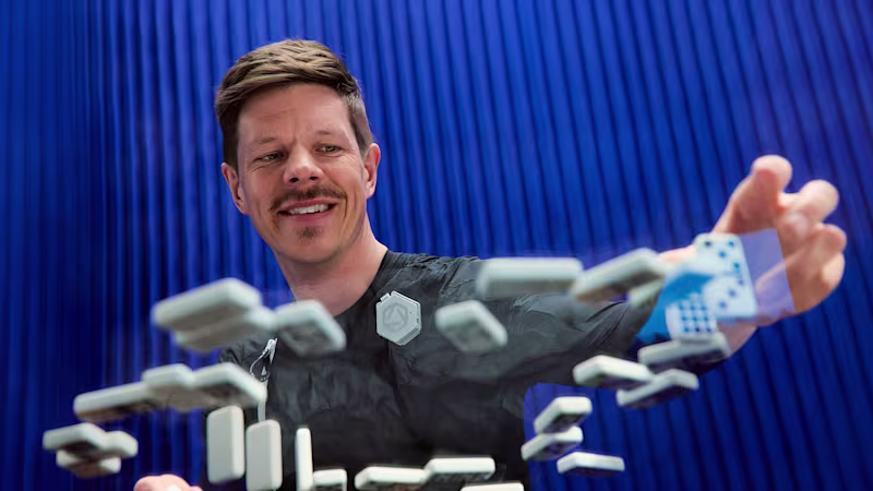 Ottobock exopulse user in front of a blue background picking up Domino pieces