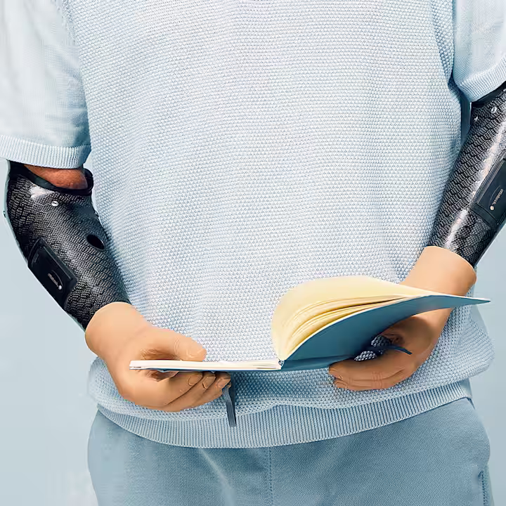 Prosthetic user holding a book