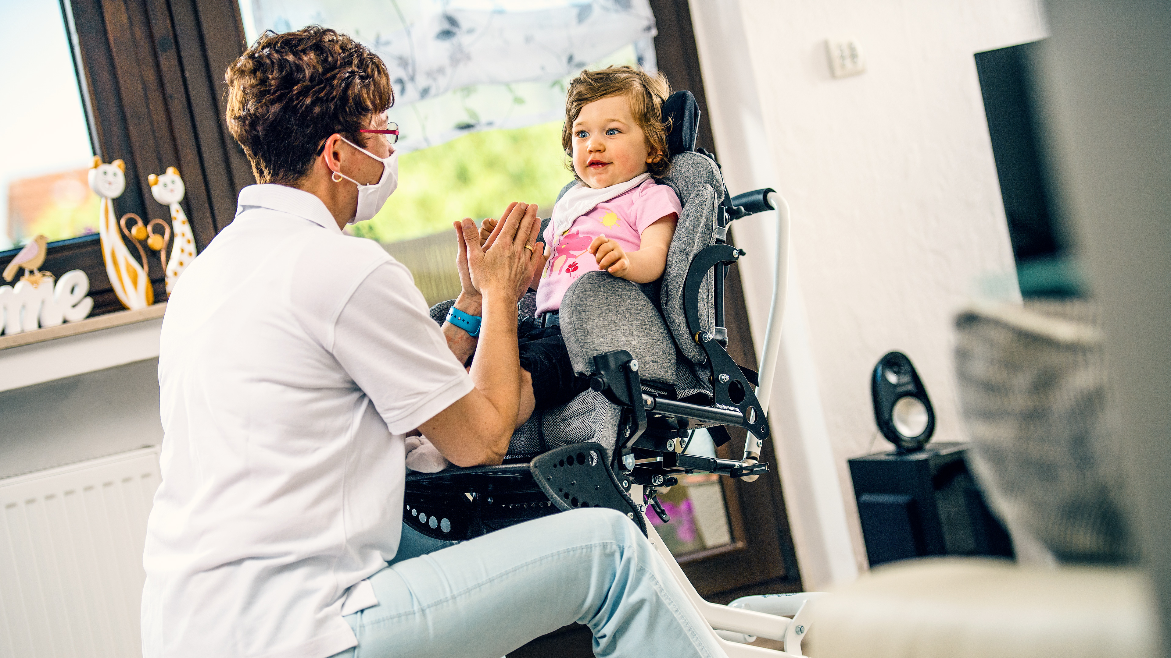 Mira sits in her Kimba and looks at a woman